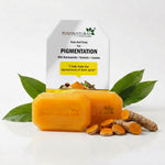 Two orange-yellow bars of 7 Days Natural Pigmentation soap displayed in front of their white packaging box, styled with fresh green leaves, turmeric root, and turmeric slices on a clean white background.