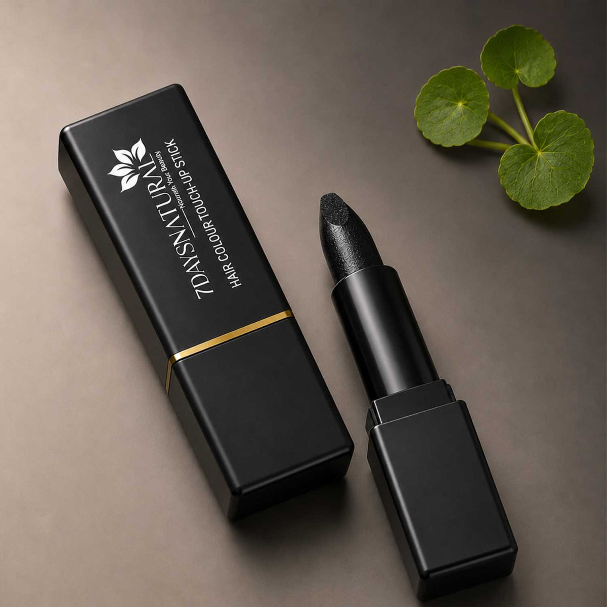 Black hair color touch-up stick with packaging on a brown background