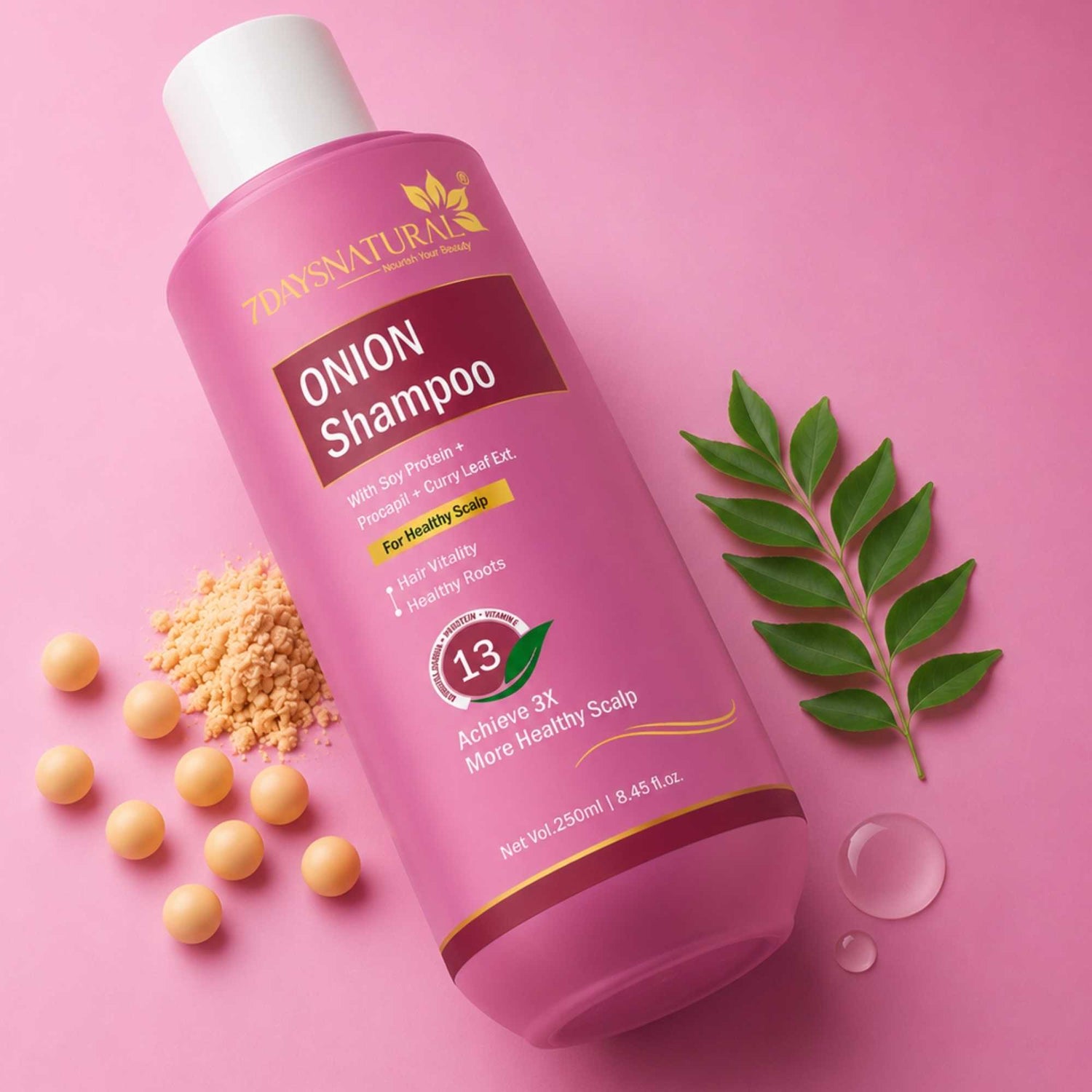 Pink bottle of onion shampoo with ingredients on a pink background