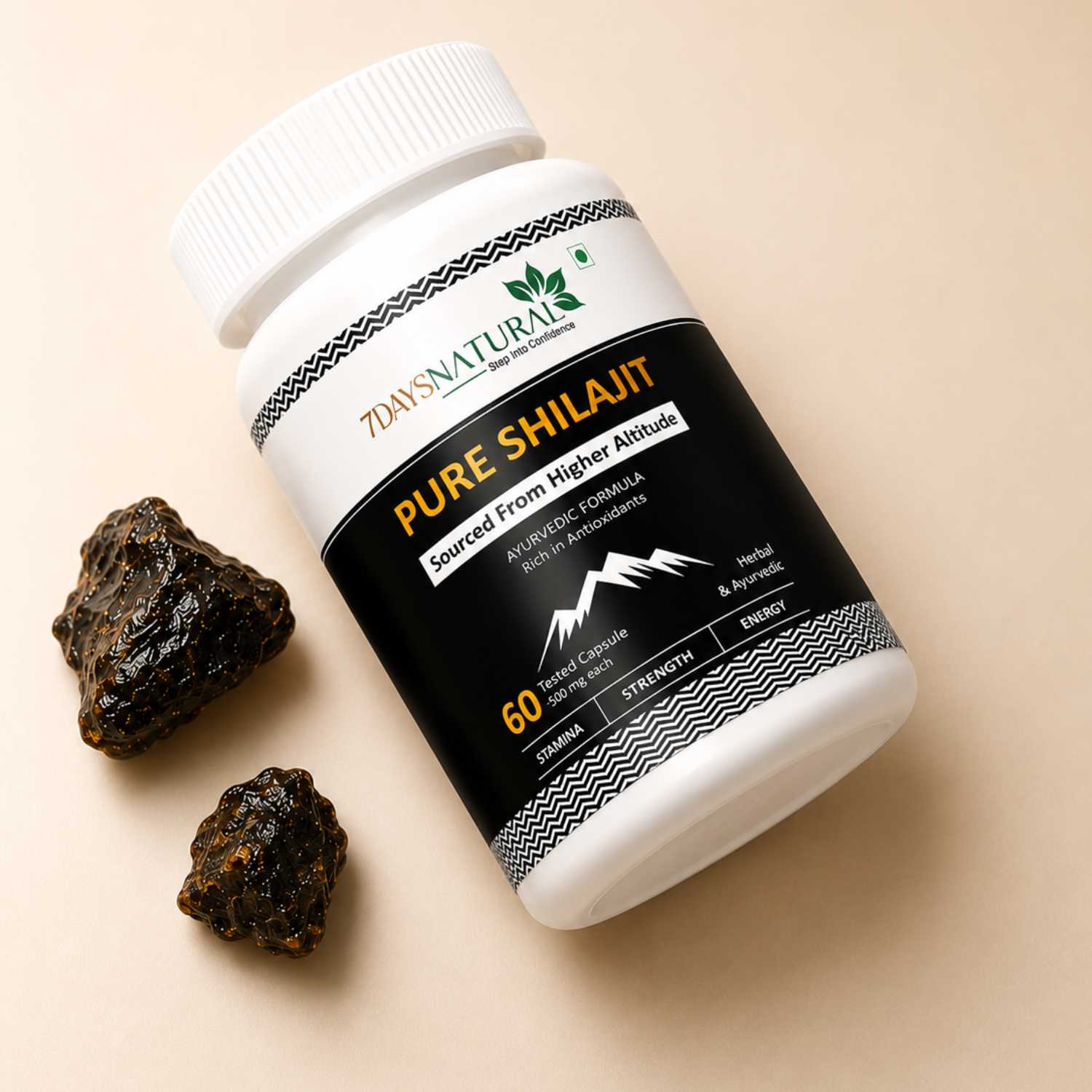 Bottle of 7days Naturals Pure Shilajit on a beige background with two pieces of shilajit.