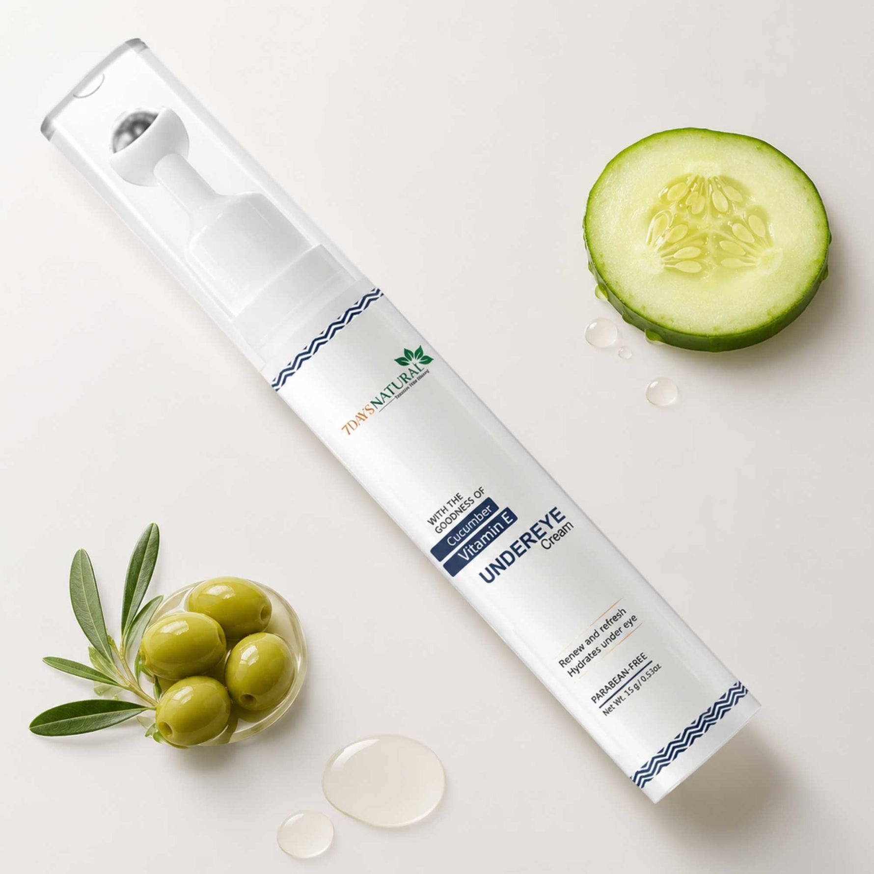 Zao Naturals Under Eye Cream bottle with a cucumber slice and green olives on a white background